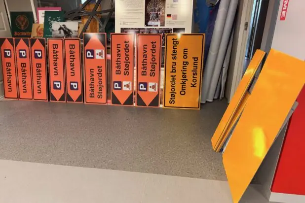Oransje henvisningsskilt til båthavn og gule omkjøringsskilt for stengt bru, produsert med godkjent refleksfolie.