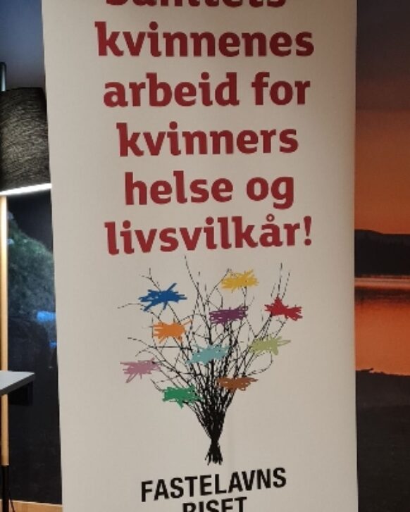 En hvit rollup med rød tekst som oppfordrer til å støtte Sanitetens arbeid for kvinners helse og livsvilkår.